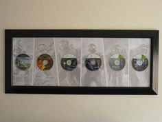 a framed photo with cd's on the wall in front of it and below them