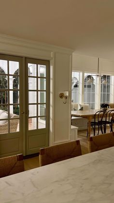 an open kitchen and dining room with french doors