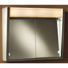 an empty bathroom cabinet with two doors on the side and a light fixture above it