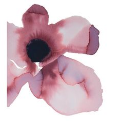 a pink flower with black center sitting on top of a white surface