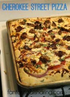 a cheesy pizza sitting on top of a stove