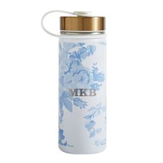 a white and blue floral water bottle with a gold lid