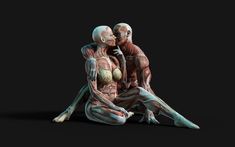 an image of two people sitting on the ground with their arms around each other and muscles exposed