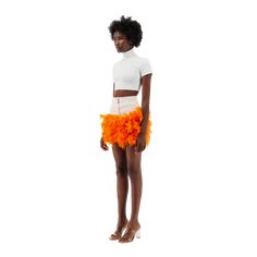 Mini off-white denim skirt with orange feather trim on the hemDetails- Body fit - High waisted - Two front side pockets - Metallic zipper and button closure- Orange feather trim- Hem ends at mid thigh Size & Fit- Refer to our size guide to choose your perfect size - Model height is 180 CM, 5'11- The model is size XXS, wearing a size XXS Care- Hand wash only- Fast dry feathers ( hair dryer does the trick)Composition- Feathers- CottonMade in UAE Spring Mini Skirt With Feather Trim, Spring Mini Skirt With Feathers, Spring Feather Trim Fitted Mini Skirt, Fitted Feather Mini Skirt, Spring Fitted Feather Skirt, Chic Feathered Summer Skirt, Fitted Feather Trim Mini Skirt For Spring, Chic Feathered Bottoms For Summer, Spring Fitted Mini Skirt With Feather Trim