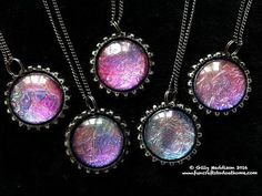 four necklaces with different designs on them