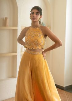 Editor's Note Featuring Sunshine Yellow Sharara Cape Set Fabric: Silk Organza, Crepe Color: Yellow Components: Sharara, cape and blouse Embroidery Details: Zardozi Hand Embroidery Care: Dry Clean Only About the Designer Mani Bhatia's collection which is a union of sophistication and comfort infused with aesthetics and calming shades.Mani Bhatia make sure to permeate life in our traditional designs with modern looks through opposing colours Luxury Yellow Sharara With Gold Embroidery, Cheap Yellow Art Silk Traditional Wear, Sharara For Haldi Ceremony, Haldi Function Dress Plus Size, Luxury Yellow Festive Sets, Sharara Designs For Haldi Ceremony, Blouse Sharara Set, Aesthetic Diwali Outfits, Yellow Ethnic Wear For Haldi