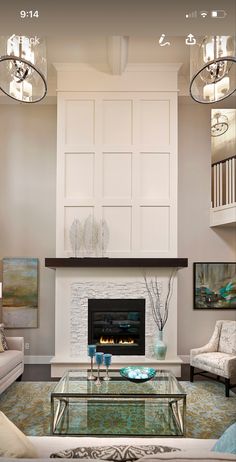 a living room filled with furniture and a fire place in the middle of a room