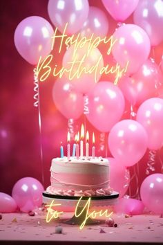 a birthday cake with lit candles surrounded by pink balloons and streamers that spell happy birthday to you