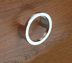 a close up of a wooden surface with a ring on the top and bottom of it