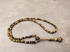 Tiger eye necklace mala rosary 108 prayer beads, natural genuine yellow gemstone  Assembled by professional macrame master, durable construction Natural yellow yellow tiger eye gemstone Necklace and mala 108 beads Beads size: 6mm Necklace length: 64cm Yellow Spiritual Jewelry With Gemstone Beads, Spiritual Yellow Jewelry With Gemstone Beads, Spiritual Yellow Gemstone Beads Jewelry, Meditation Rosary With 108 Beads, Yellow Hand-strung Jewelry For Meditation, Adjustable Natural Stones Rosary For Meditation, Gold Healing Mala With 108 Beads, Gold Mala With 108 Beads For Healing, Adjustable Brown Gemstone Beads Mala