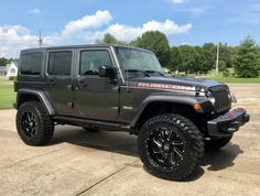 a black jeep parked on top of a parking lot