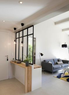 a living room filled with furniture next to a window