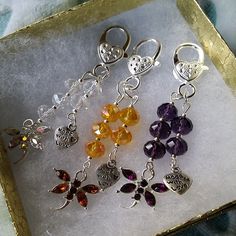 six different colored charms are in a box