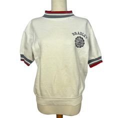 "Classic collegiate sweatshirt from the 60s! Super comfortable and has an oversized fit. From the 1960s!  Measurements: Bust: 40\" Waist: 40\"-42\" Hem: 32\"-38\"  Length: 23\" Shoulder to Shoulder: 20\" Sleeve Length: 8\" Armhole Opening: 8\"-10\"  Condition: Good condition, a few stains on the front and back (see images)" Varsity Crew Neck Top With Ribbed Collar, Varsity Style Relaxed Fit Top With Ribbed Collar, Vintage Crew Neck Tops For Campus, Retro White Top With Ribbed Collar, White Retro Top With Ribbed Collar, Retro Cotton Sweatshirt With Ribbed Collar, Retro Crew Neck Tops For Campus, Retro Sweatshirt With Ribbed Collar For Streetwear, Retro Cotton Sweatshirt For Campus