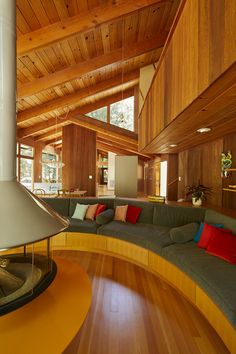 a living room filled with furniture and wooden walls