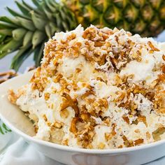 a white bowl filled with food next to a pineapple