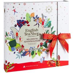 an english tea shop gift box with red ribbon and bow on the front, decorated with christmas decorations