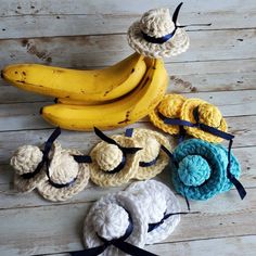 several crocheted items are arranged on a wooden surface with bananas in the background