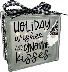 a glass block with the words, holiday wishes and gnome kisses on it's side