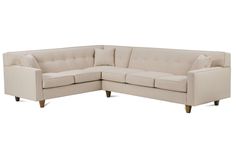 an image of a sectional couch with pillows on the top and bottom part of it