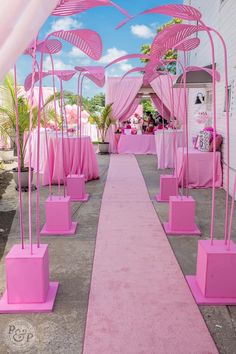 a long pink walkway lined with chairs and umbrellas