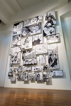 a bunch of black and white pictures hanging on the side of a wall next to a wooden floor