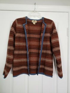 Vintage Woolrich Sweater Cardigan 100% Wool Button Ribbon Raisin Brown Large. Great condition! Lovely striped design with blue trim. Colors are like a rust/orange brown, dark brown and tan. *Pilling throughout, kind of itchy like most pure wool.* Approx. measurements (when buttoned)- Pit to pit: 19" Length from shoulder to bottom hem: 24" Sleeve length: 24" Will ship out within 1 business day of payment. Thanks! Vintage Long Sleeve Cardigan For Layering, Vintage Style Long Sleeve Cardigan For Layering, Vintage Brown Sweater For Layering, Vintage Brown Long Sleeve Cardigan, Brown Vintage Long Sleeve Cardigan, Vintage Brown Cardigan With Button Closure, Vintage Brown Outerwear For Layering, Funky Cardigans, Retro Sweaters