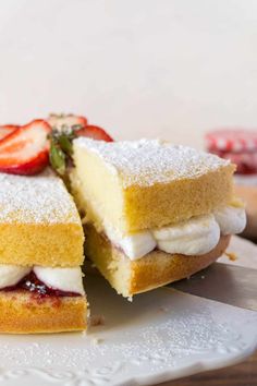 a strawberry shortcake cut in half on a white plate