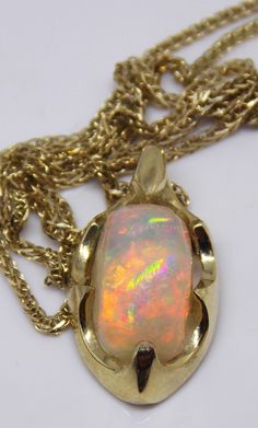 "One of a kind top quality handmade stunning 14k gold Welo 1.8ct AAA opal pendant!! It is an especially precious item, a rare gift to someone that you cherish, a powerful expression of love and friendship. Surprise your special someone with this spectacular opal pendant! This amazing, large opal rainbow boasts a colorful floral pattern with vibrant color rainbow color that changes with every gentle motion. Indirect sunlight, it looks really glamorous and replaces colors .... A truly joyous stone Gold Ethiopian Opal Cabochon Jewelry, Yellow Gold Ethiopian Opal Cabochon Jewelry, Opal Cabochon Yellow Gold Jewelry, Yellow Gold Opal Cabochon Jewelry, Unique Yellow Gold Opal Necklaces, Unique Yellow Gold Opal Necklace, Unique Yellow Gold Ethiopian Opal Jewelry, Handmade Yellow Gold Jewelry With Ethiopian Opal, Opal Bracelet Gold