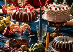 a table topped with cakes and desserts covered in frosting