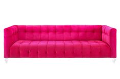 a pink couch sitting on top of a white floor