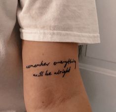 a woman with a tattoo on her arm that says, somewhere everything will be alright