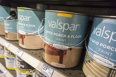 several cans of valpspar paint on display in a store