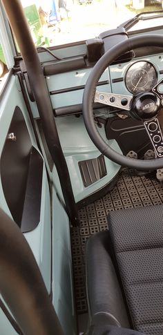 the interior of a vehicle with steering wheel and dashboard