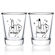 two shot glasses with hand gestures drawn on them