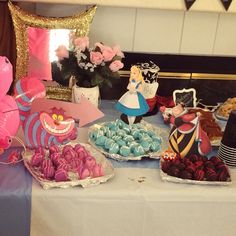 a table topped with cakes and desserts covered in frosting