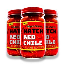 three jars of red chili on a white background