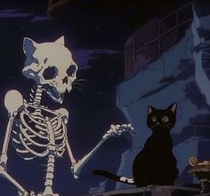 a cat sitting next to a skeleton in the dark