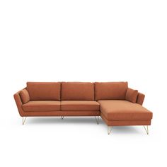 an orange sectional sofa with gold legs and a foot rest in front of a white background