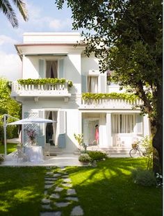 the house is white and has many balconies