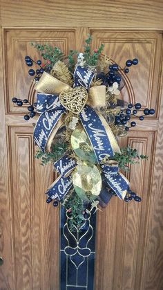 a blue and gold christmas wreath on the front door