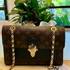 Louis Vuitton Monogram Victorie Vavin Noir Shoulder Chain Handbag. Very Hard To Find Once You Open The Gold Tone Push Lock. It Opens To A Black Calf, Leather Front Pocket. It Has Three Interior Pockets The Center One Has A Zipper Closure. This Purse Can Be Short Or Long Or Even As A Crossbody. Makes It Very Versatile. The Measurements Are : H - 7” W - 10” D - 3” Strap Drop - 12” (Double) / 22” (Single) This Handbag Was Made In Spain And The Date Code Is Ca0128. This Bag Is Absolutely Gorgeous! I Promise You Will Receive Many Compliments When You Show Up With This Bag On Your Shoulder. This Will A Great Gift For Yourself Or Mother’s Day Is Coming Up. Anyone Would Be Thrilled Noir Color, Shoulder Chain, Louis Vuitton Monogram, Victorious, Louis Vuitton Bag, Mother’s Day, Black And Brown, Bag Lady, Louis Vuitton