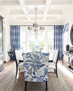 a dining room with blue and white chairs