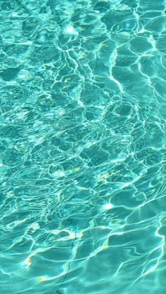 the water is very clear and blue with little ripples on it's surface