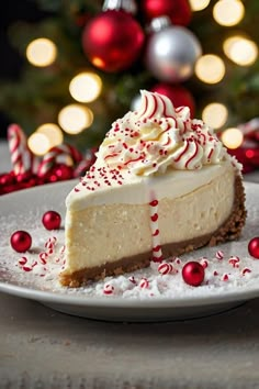 a white plate topped with a slice of cheesecake covered in whipped cream and candy canes