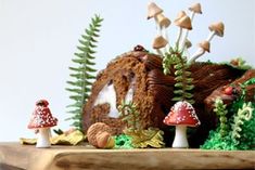 a cake with mushrooms and plants on it