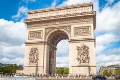 the arc triumph in paris, france with cars passing by it and people walking around