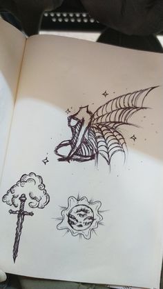 an open book with drawings on it and a drawing of a spiderweaver