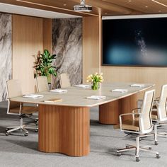 an empty conference room with chairs and a flat screen tv mounted on the wall above it