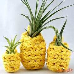 three pineapples made out of yellow yarn